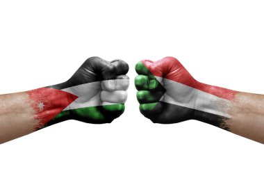Two hands punch to each others on white background. Country flags painted fists, conflict crisis concept between jordan and sudan