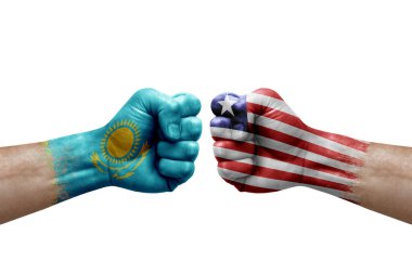 Two hands punch to each others on white background. Country flags painted fists, conflict crisis concept between kazakhstan and liberia