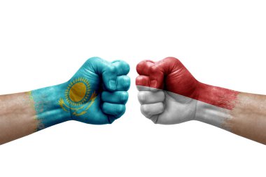 Two hands punch to each others on white background. Country flags painted fists, conflict crisis concept between kazakhstan and monaco