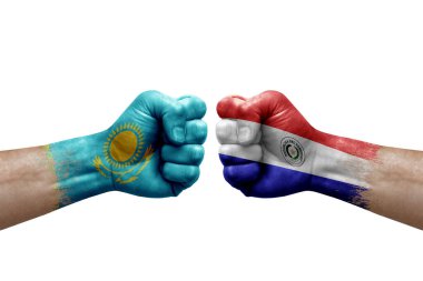 Two hands punch to each others on white background. Country flags painted fists, conflict crisis concept between kazakhstan and paraguay