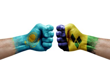Two hands punch to each others on white background. Country flags painted fists, conflict crisis concept between kazakhstan and saint vincent and the grenadines