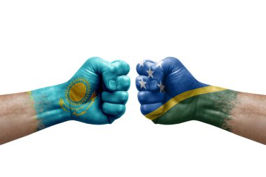 Two hands punch to each others on white background. Country flags painted fists, conflict crisis concept between kazakhstan and solomon islands