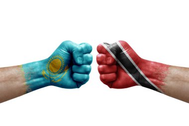Two hands punch to each others on white background. Country flags painted fists, conflict crisis concept between kazakhstan and tobago