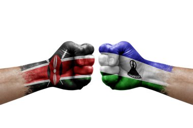 Two hands punch to each others on white background. Country flags painted fists, conflict crisis concept between kenya and lesotho