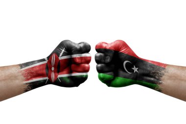 Two hands punch to each others on white background. Country flags painted fists, conflict crisis concept between kenya and libya