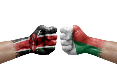 Two hands punch to each others on white background. Country flags painted fists, conflict crisis concept between kenya and madagascar