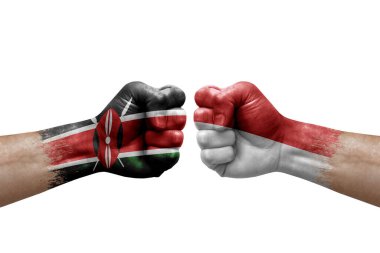 Two hands punch to each others on white background. Country flags painted fists, conflict crisis concept between kenya and monaco