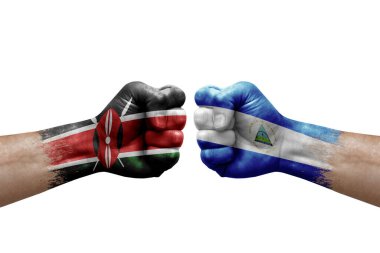Two hands punch to each others on white background. Country flags painted fists, conflict crisis concept between kenya and nicaragua