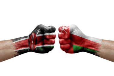 Two hands punch to each others on white background. Country flags painted fists, conflict crisis concept between kenya and oman