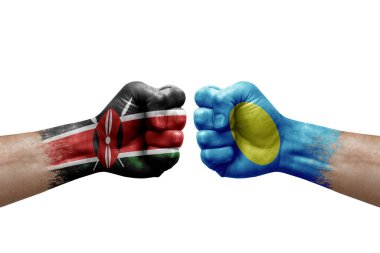 Two hands punch to each others on white background. Country flags painted fists, conflict crisis concept between kenya and palau