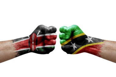 Two hands punch to each others on white background. Country flags painted fists, conflict crisis concept between kenya and saint kitts and nevis