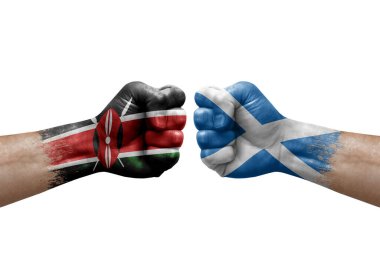 Two hands punch to each others on white background. Country flags painted fists, conflict crisis concept between kenya and scotland