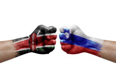 Two hands punch to each others on white background. Country flags painted fists, conflict crisis concept between kenya and slovenia