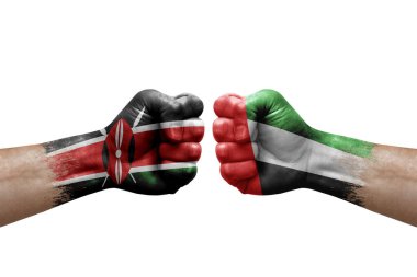 Two hands punch to each others on white background. Country flags painted fists, conflict crisis concept between kenya and united arab emirates