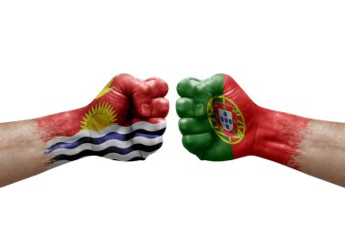 Two hands punch to each others on white background. Country flags painted fists, conflict crisis concept between kiribati and portugal