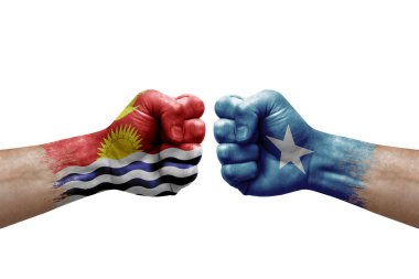 Two hands punch to each others on white background. Country flags painted fists, conflict crisis concept between kiribati and somalia