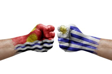 Two hands punch to each others on white background. Country flags painted fists, conflict crisis concept between kiribati and uruguay