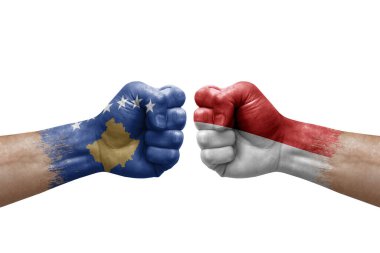 Two hands punch to each others on white background. Country flags painted fists, conflict crisis concept between kosovo and monaco