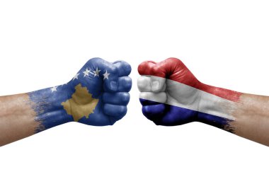 Two hands punch to each others on white background. Country flags painted fists, conflict crisis concept between kosovo and netherlands