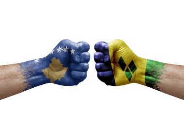 Two hands punch to each others on white background. Country flags painted fists, conflict crisis concept between kosovo and saint vincent and the grenadines