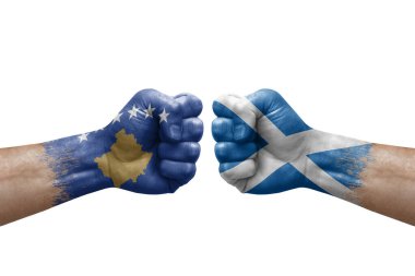Two hands punch to each others on white background. Country flags painted fists, conflict crisis concept between kosovo and scotland