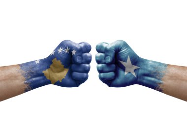 Two hands punch to each others on white background. Country flags painted fists, conflict crisis concept between kosovo and somalia