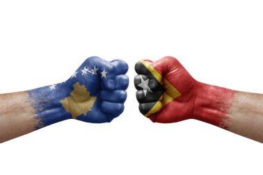 Two hands punch to each others on white background. Country flags painted fists, conflict crisis concept between kosovo and timor leste