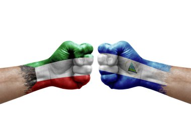 Two hands punch to each others on white background. Country flags painted fists, conflict crisis concept between kuwait and nicaragua
