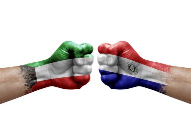 Two hands punch to each others on white background. Country flags painted fists, conflict crisis concept between kuwait and paraguay