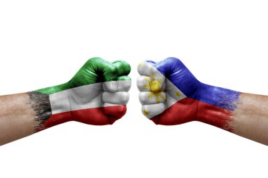 Two hands punch to each others on white background. Country flags painted fists, conflict crisis concept between kuwait and philippines