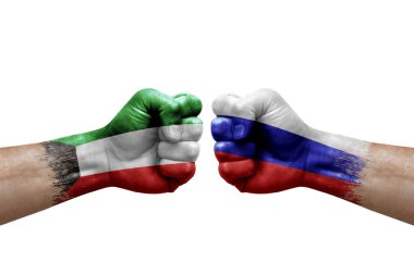 Two hands punch to each others on white background. Country flags painted fists, conflict crisis concept between kuwait and russia