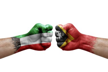 Two hands punch to each others on white background. Country flags painted fists, conflict crisis concept between kuwait and timor leste