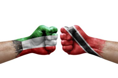 Two hands punch to each others on white background. Country flags painted fists, conflict crisis concept between kuwait and tobago