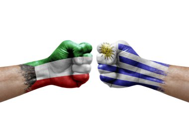 Two hands punch to each others on white background. Country flags painted fists, conflict crisis concept between kuwait and uruguay