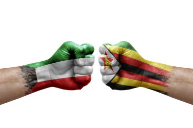 Two hands punch to each others on white background. Country flags painted fists, conflict crisis concept between kuwait and zimbabwe