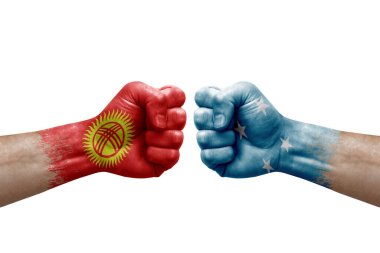 Two hands punch to each others on white background. Country flags painted fists, conflict crisis concept between kyrgyzstan and micronesia