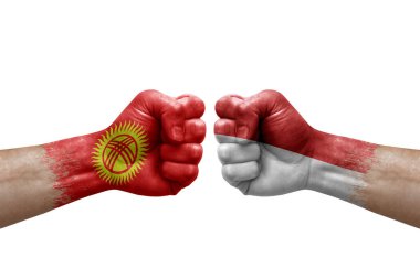 Two hands punch to each others on white background. Country flags painted fists, conflict crisis concept between kyrgyzstan and monaco