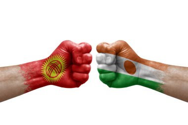 Two hands punch to each others on white background. Country flags painted fists, conflict crisis concept between kyrgyzstan and niger