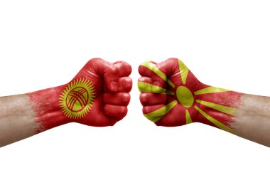 Two hands punch to each others on white background. Country flags painted fists, conflict crisis concept between kyrgyzstan and north macedonia