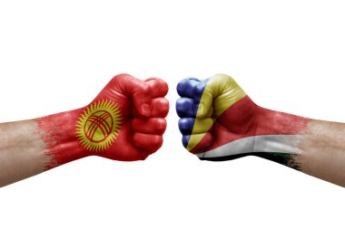 Two hands punch to each others on white background. Country flags painted fists, conflict crisis concept between kyrgyzstan and seychelles