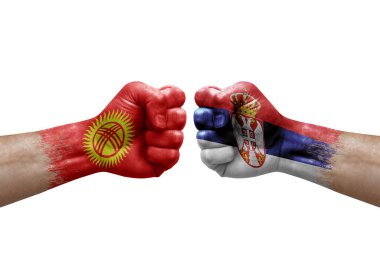 Two hands punch to each others on white background. Country flags painted fists, conflict crisis concept between kyrgyzstan and serbia