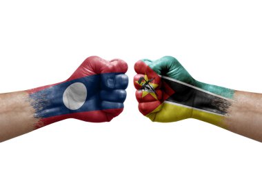 Two hands punch to each others on white background. Country flags painted fists, conflict crisis concept between laos and mozambique