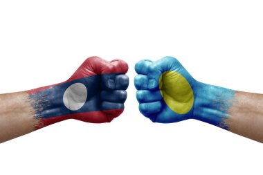 Two hands punch to each others on white background. Country flags painted fists, conflict crisis concept between laos and palau