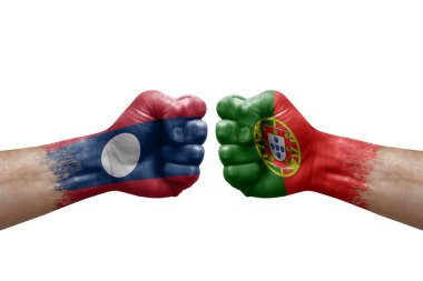 Two hands punch to each others on white background. Country flags painted fists, conflict crisis concept between laos and portugal