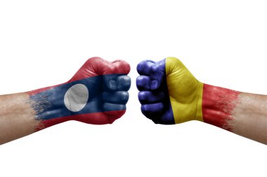 Two hands punch to each others on white background. Country flags painted fists, conflict crisis concept between laos and romania