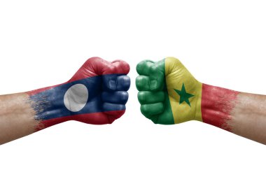 Two hands punch to each others on white background. Country flags painted fists, conflict crisis concept between laos and senegal