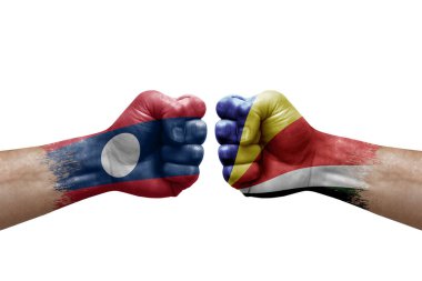 Two hands punch to each others on white background. Country flags painted fists, conflict crisis concept between laos and seychelles