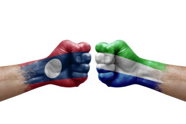 Two hands punch to each others on white background. Country flags painted fists, conflict crisis concept between laos and sierra leone