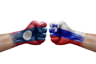 Two hands punch to each others on white background. Country flags painted fists, conflict crisis concept between laos and slovenia