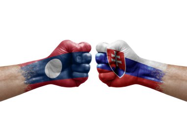 Two hands punch to each others on white background. Country flags painted fists, conflict crisis concept between laos and slovakia
